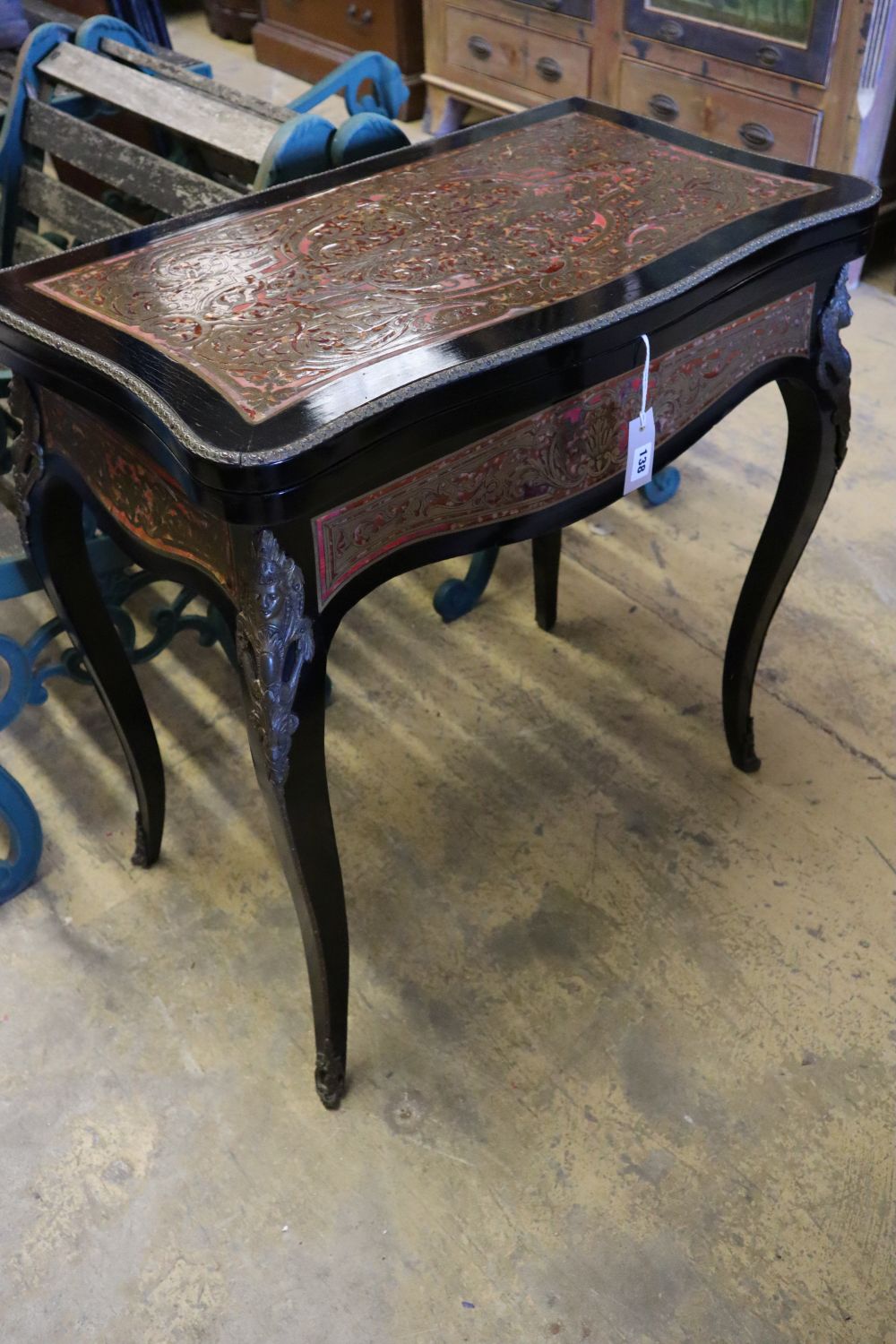A 19th century French red boullework and ebony card table, with serpentine top, width 74cm